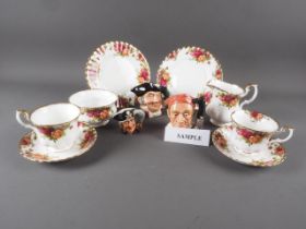 A Royal Albert "Old Country Roses" part teaset for six and three Royal Doulton character jugs
