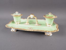A 19th century English porcelain green and gilt decorated double ink stand, 11" wide