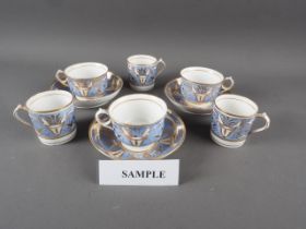 An 18th century part tea and coffee set with white and gilt scrolled decoration, on a blue ground