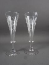 A pair of 19th century ale glasses with bladed knopped stems and engraved wheat and leaf decoration,