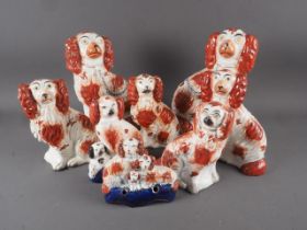 Two pairs of 19th century Staffordshire spaniels, 10" high, two smaller spaniels, an inkwell and a