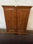 A Victorian pitch pine two door cabinet, doors opening to reveal shelves within 35.