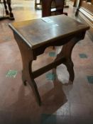 A 19th century mahogany organ seat of canted form, supports united by a solid stretcher,