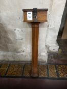 A 19th century oak wall mounted collection box raised over a shaped pillar style column,