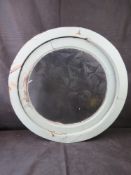 A hardwood round window with frosted glass.