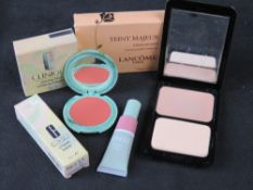 Three Clinique makeup compacts/items in original packaging.