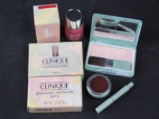 Three Clinique makeup compacts/items in original packaging.