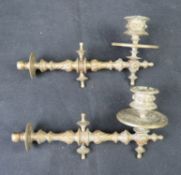 A pair of brass piano candle sconces.