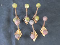 A set of six mid century coat hooks.