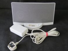 A Bose SoundDock with charger cable.