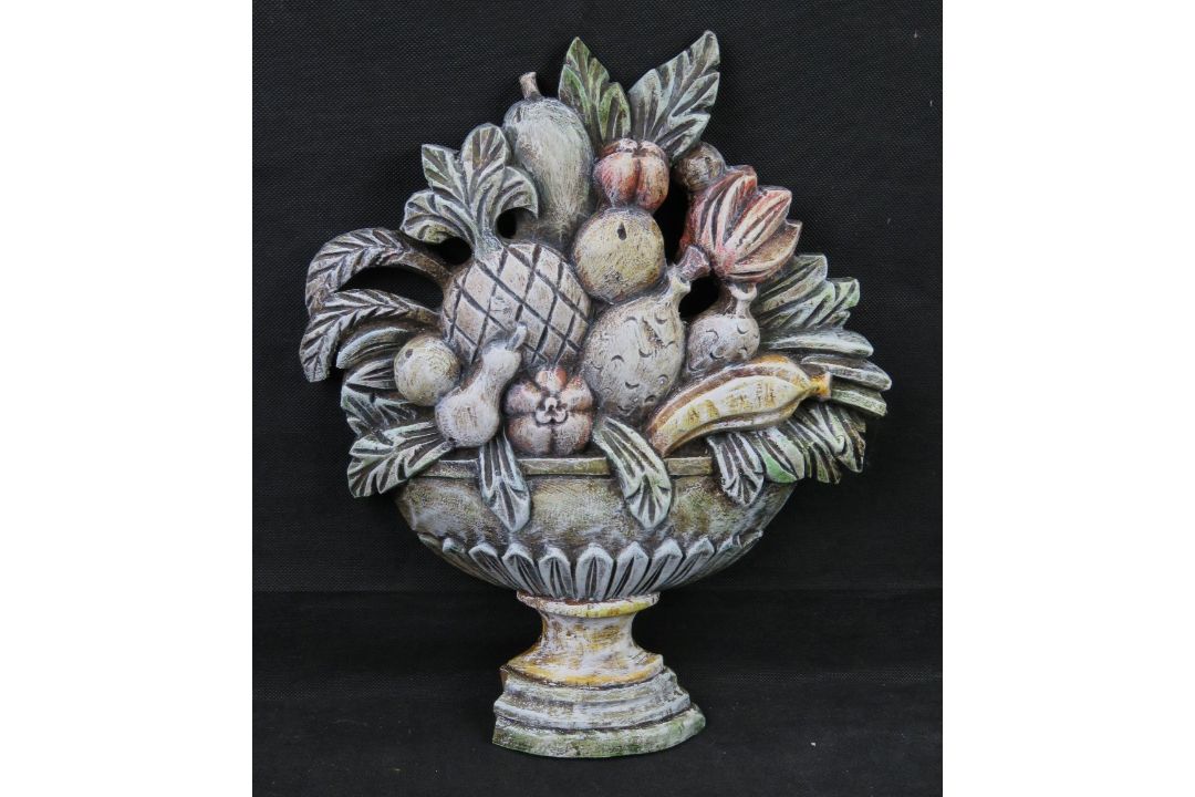 A carved and painted wooden decorative p