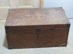 A pine blanket box or trunk having metal end handles and corner bracing, measuring 67 x 39 x 32cm.