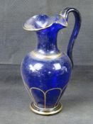 A Bristol blue glass gilded water jug.