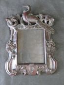 A carved black forest type photograph frame having bird over and 9 in shield under, original glass,