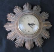 A mid century Smiths Sectric sunburst wall clock.