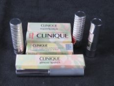 Four Clinique lipsticks in original packaging.