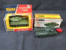 Two model tanks in original packaging being Dinky and Corgi.