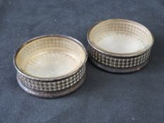A pair of silver plated butter dishes.