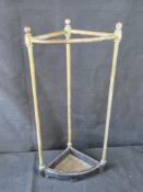 A brass and cast iron umbrella stand, early 20th century, with drip tray.
