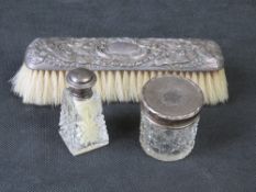 A hallmarked silver and cut glass smelling salts bottle with two other hallmarked silver items.