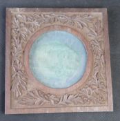 A 19th century carved wooden frame, silk covered panel to back.