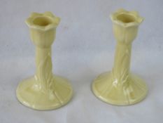 A pair of Sodahl cramic floral candlesticks.