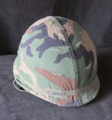 A camouflage covered helmet.