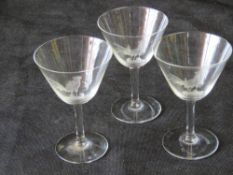 A set of three cocktail glasses etched cockerels upon.