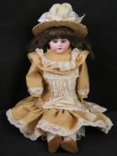 An Ernst Heubach doll having leather body and cloth feet,