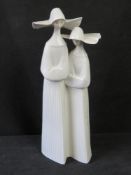 A large Lladro figurine of two nuns.