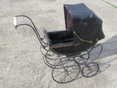 A late 19th century dolls pram black painted with matching leather-cloth hood and buttoned seat