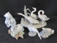 Three Lladro greese figurines together with a polar bear and a rabbit also by Lladro.