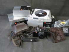 A Leica D-Lux 5 camera and accessories.
