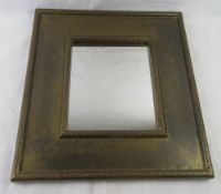 A brass framed mirror having foliate design upon, mirror 30 x 25cm, overall 51 x 56cm.