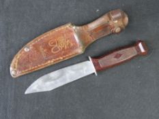 A small hunting dagger with sheath.