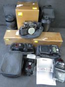 A Nikon F2 7279708 camera together with a quantity of Nikon VR lenses, lights, etc.