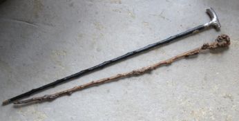 Two walking canes, one having silver (naive repairs) top and yellow metal monogram upon.
