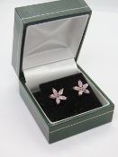 A pair of silver and pink stone flower earrings in presentation box.