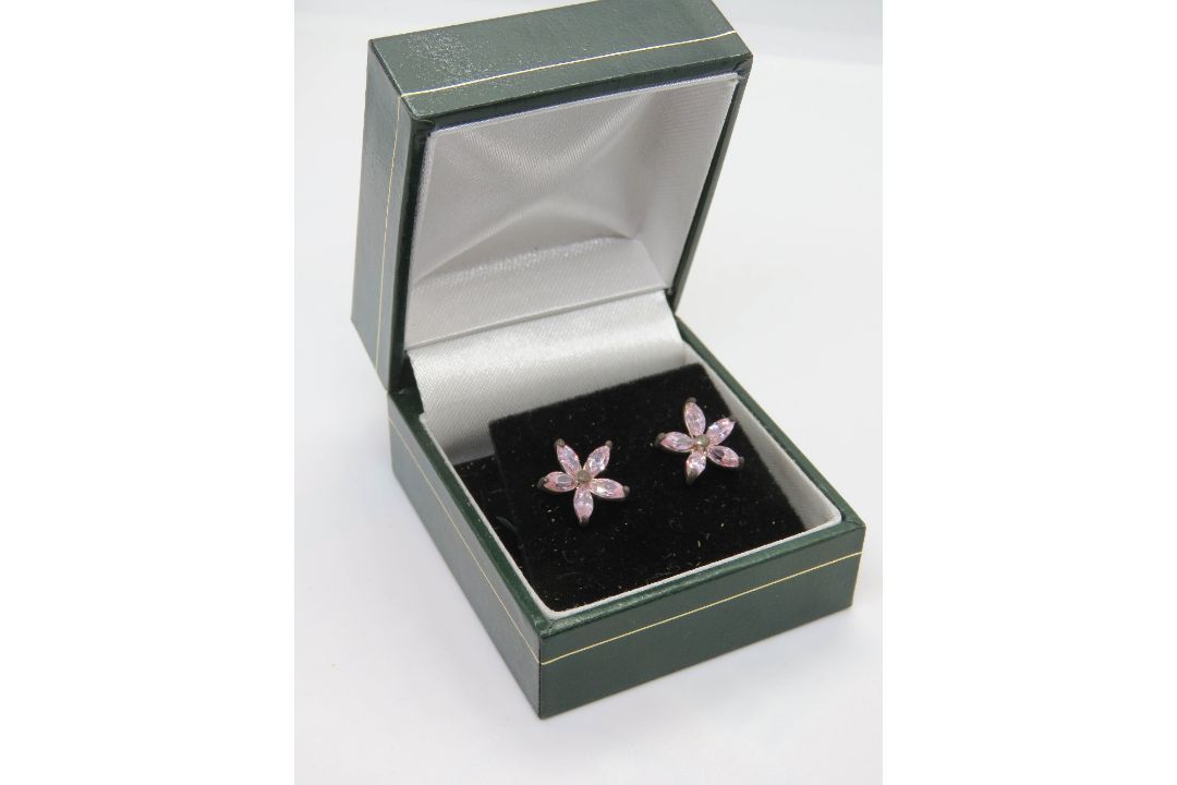 A pair of silver and pink stone flower earrings in presentation box.