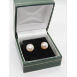 A pair of silver and pearl earrings in presentation box.