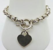 A heavy silver charm bracelet with heart tag, hallmarked 925, 31.5g.