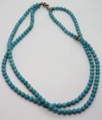 A turquoise bead necklace, can be looped for double row or worn as single row with loop for pendant.