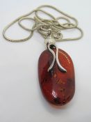 A large Barlic amber and silver pendant, with white metal chain, pandant approx 5.5cm inc bale.