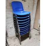 Ten blue plastic stacking chairs.