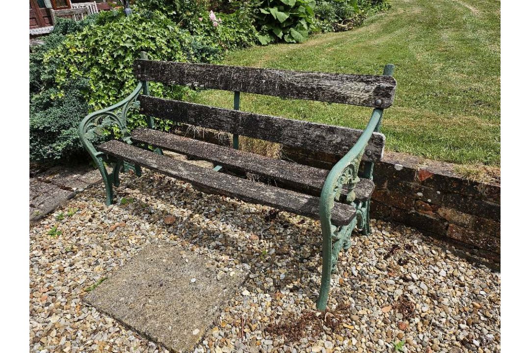 A garden bench with cast iron ends, approx 152cm wide. - Image 1 of 3
