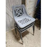 Three plastic stacking chairs.