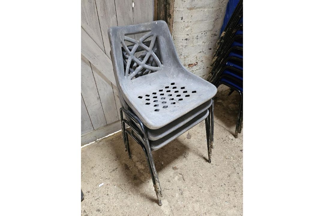 Three plastic stacking chairs.