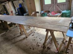 A long pine toped trestle table having three supports, 360 x 86cm.