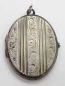 A white metal locket, no apparent hallmarks.