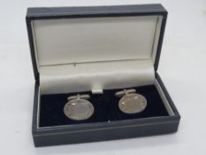 A pair of unengraved silver cufflinks in presentation box.